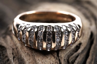 Lot 143 - A contemporary diamond dress ring with captive set diamonds