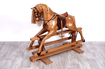 Lot 202 - A good quality pine and laminate rocking horse