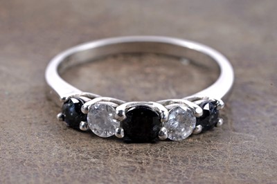 Lot 155 - A sapphire and diamond half hoop eternity ring