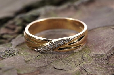 Lot 559 - A diamond twist-pattern half-hoop eternity ring