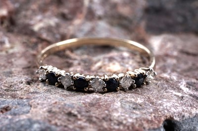 Lot 165 - A sapphire and diamond half hoop eternity ring