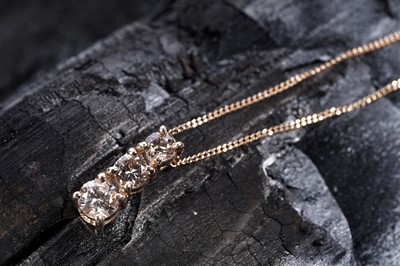 Lot 182 - A diamond pendant necklace on rose gold