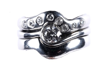 Lot 218 - A contemporary diamond and platinum bridal wedding ring set