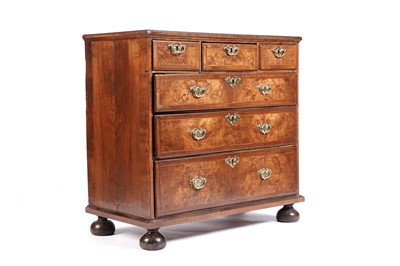 Lot 614 - A George III walnut, cross-banded and feather-banded chest of drawers