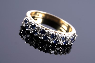 Lot 344 - A sapphire and diamond half hoop eternity ring