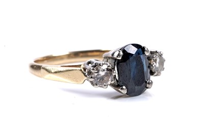 Lot 561 - A sapphire and diamond three-stone ring