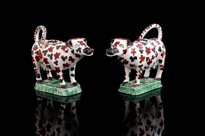 Lot 367 - A pair of Cambrian pottery cow creamers