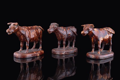 Lot 381 - Three treacle glazed cows