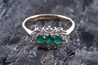 Lot 367 - A three-stone emerald ring