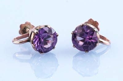 Lot 346 - A pair of synthetic sapphire colour change earrings