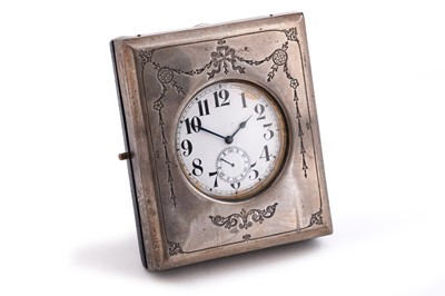 Lot 565 - A goliath pocket watch contained within a silver bedside/travel case