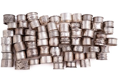 Lot 512 - A large collection of silver napkin rings; and a small selection of plated napkin rings
