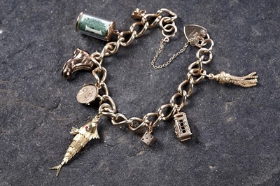 Lot 569 - A 9ct gold curb-link charm bracelet