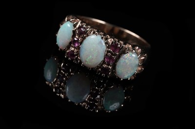 Lot 573 - A three stone opal and ruby ring