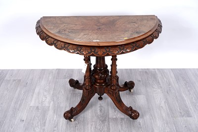 Lot 16 - A Victorian carved walnut and burr walnut games table