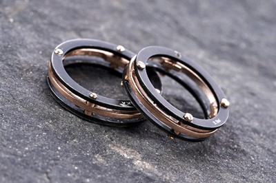 Lot 596 - Two contemporary Baraka 18ct rose gold and black steel wedding rings
