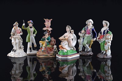 Lot 255 - Two chambersticks; and four figures