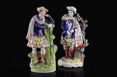 Lot 260 - Two large Staffordshire highland figures