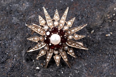 Lot 601 - A Victorian style garnet and pearl starburst pattern brooch
