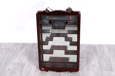 Lot 83 - An Oriental hardwood wall hanging display cabinet