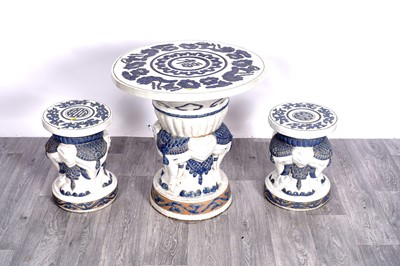 Lot 401 - An Oriental elephant table and two stools