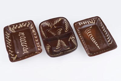 Lot 316 - A collection of three slipware dishes