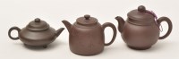 Lot 156 - Three Chinese Yixing stone ware teapots and...