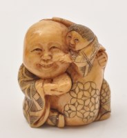Lot 194 - Japanese ivory Netsuke of man holding a child...