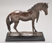 Lot 386 - A brown patinated bronze model of a stallion,...