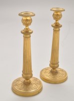 Lot 457 - A pair of giltmetal candlesticks, the urn...