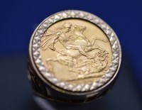 Lot 590 - A George V gold sovereign, 1911, in 9ct....
