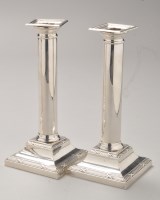 Lot 672 - A pair of George V silver candlesticks, by...