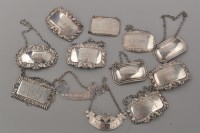 Lot 679 - Ten assorted Elizabeth II silver decanter...