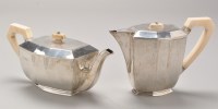 Lot 680 - A George VI silver teapot and matching hot...