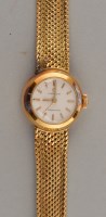 Lot 825 - Omega Ladymatic: a lady's gold bracelet watch,...