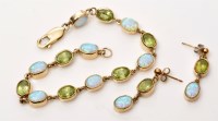 Lot 855 - An opal and peridot bracelet and matching drop...