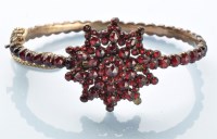 Lot 863 - A Victorian garnet bangle, set throughout with...