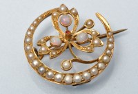 Lot 867 - A half pearl opal and ruby crescent form...