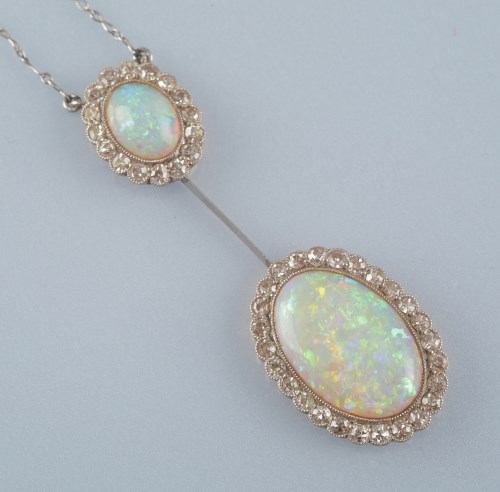 Lot 870 - An Edwardian opal and diamond double cluster...