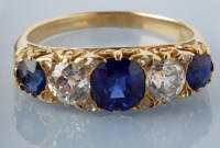 Lot 885 - A sapphire and diamond ring, the central...