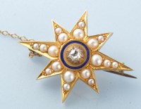 Lot 886 - A diamond, pearl, enamel and yellow metal star...