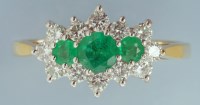 Lot 890 - An emerald and diamond cluster ring, the three...