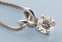 Lot 892 - A diamond solitaire pendant, the single...