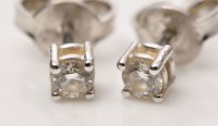 Lot 893 - A pair of diamond stud earrings, the brilliant...