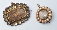 Lot 900 - Two mourning brooches, each with plaited hair...