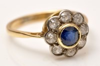 Lot 920 - A sapphire and diamond cluster ring, the...