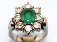 Lot 921 - An emerald and diamond cluster ring, the oval...