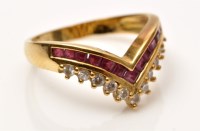 Lot 925 - A ruby and diamond ring, set with graduated...