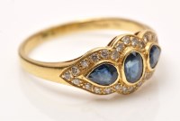 Lot 927 - A sapphire and diamond dress ring, the central...