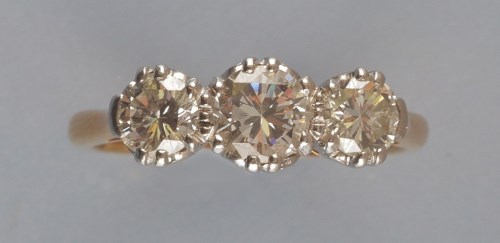 Lot 930 - A three stone diamond ring, the brilliant cut...